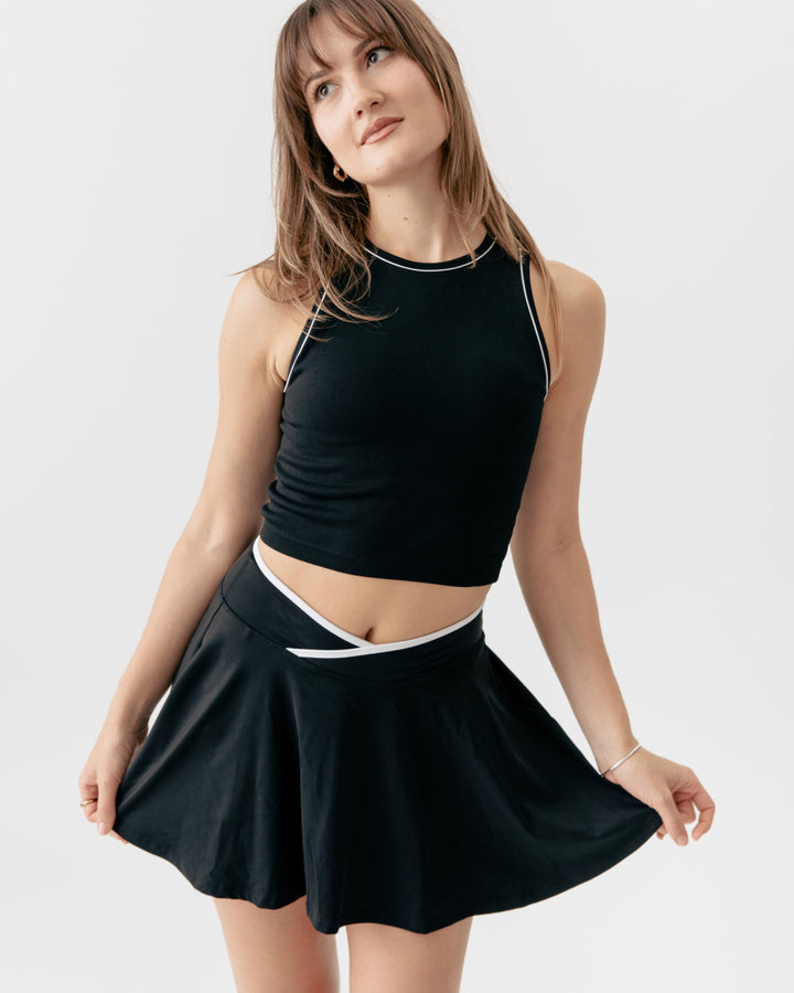 high-neck crop tank top paired with a matching crossover V-waist tennis skirt