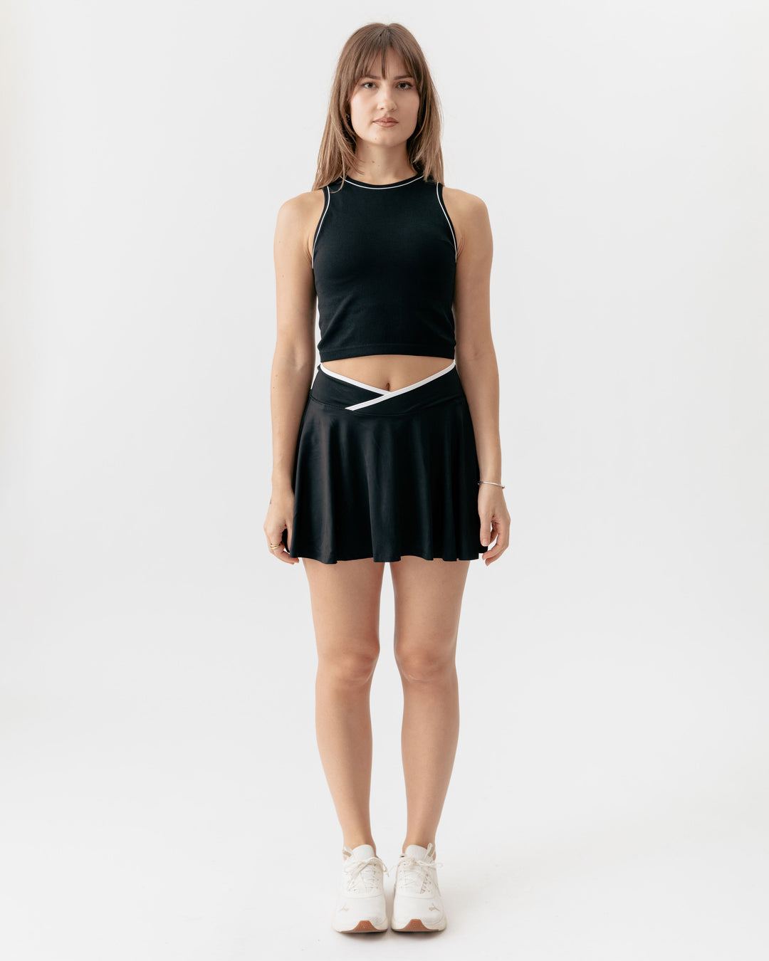 high-neck crop tank top paired with a matching crossover V-waist tennis skirt
