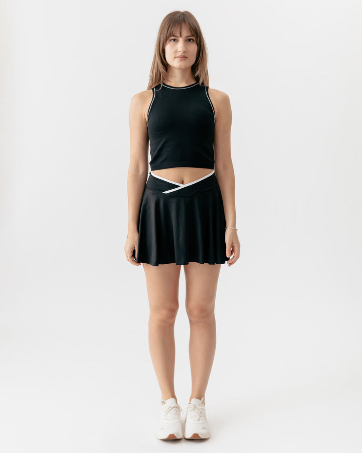 high-neck crop tank top paired with a matching crossover V-waist tennis skirt