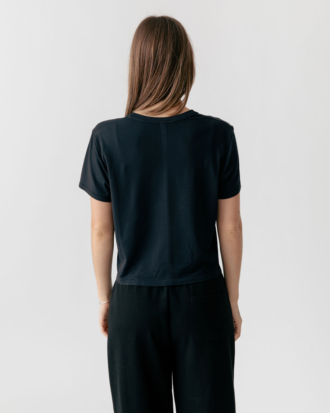 Back of Woman wearing a Black Cropped Crewneck T-Shirt