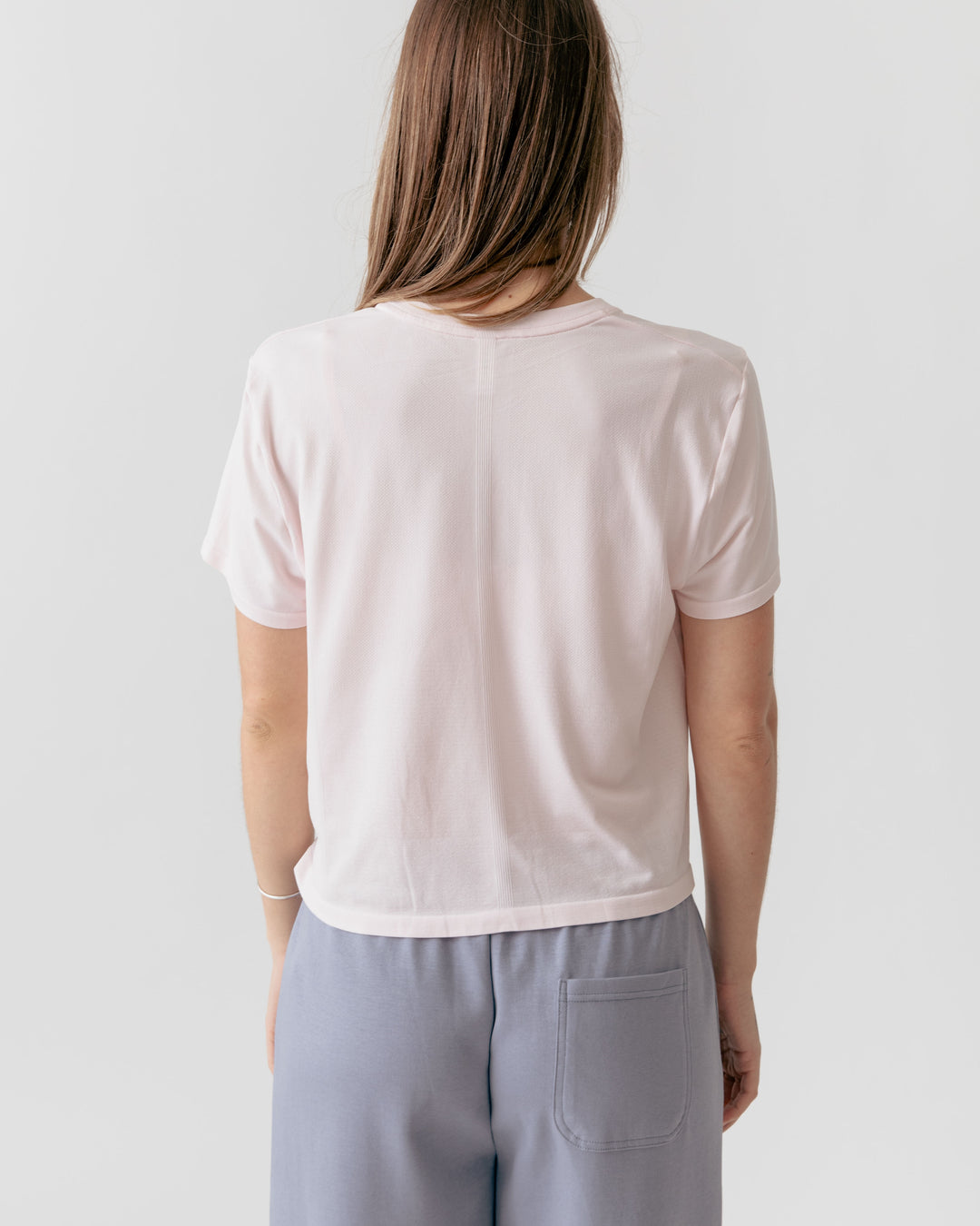 Back of Woman weating Rose Cropped Crewneck T-Shirt