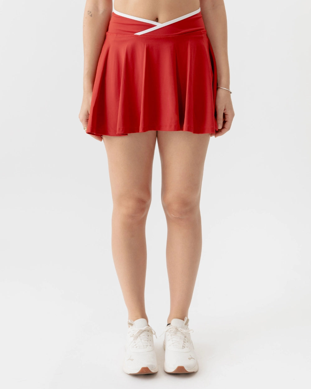 Red skirt worn by a person on a white background