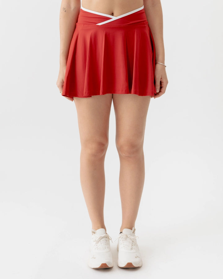 Red skirt worn by a person on a white background