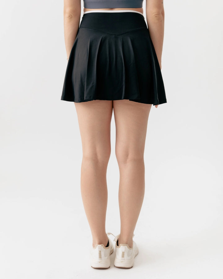Person wearing a black skirt on a white background