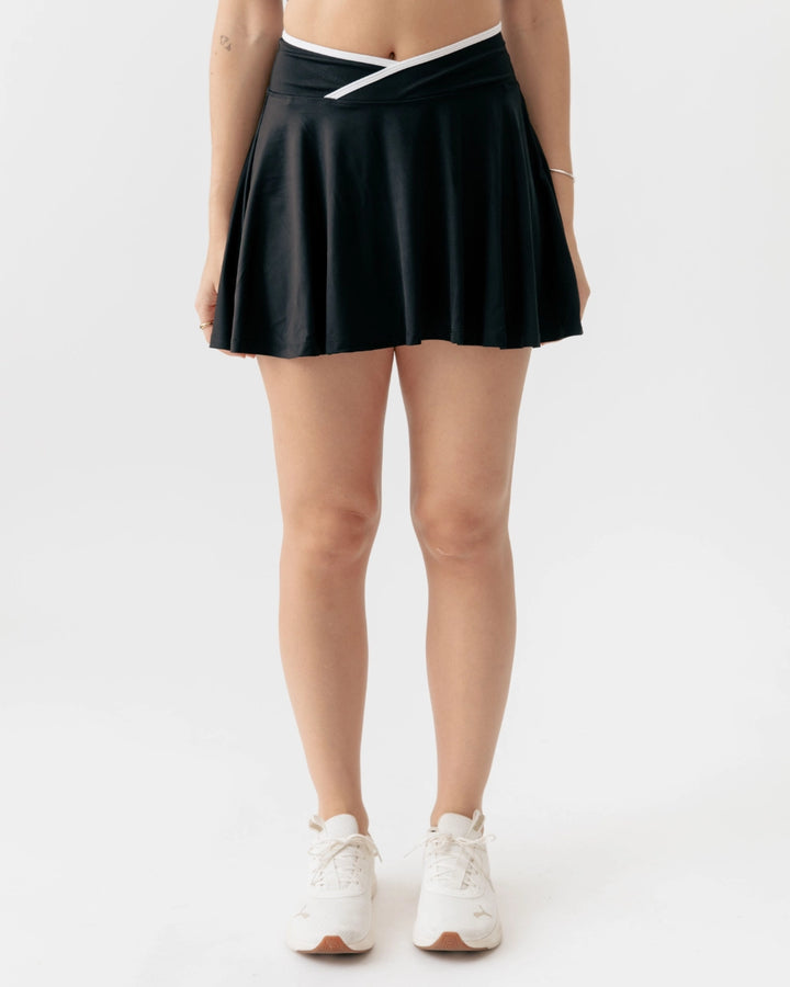 Person wearing a black skirt on a white background