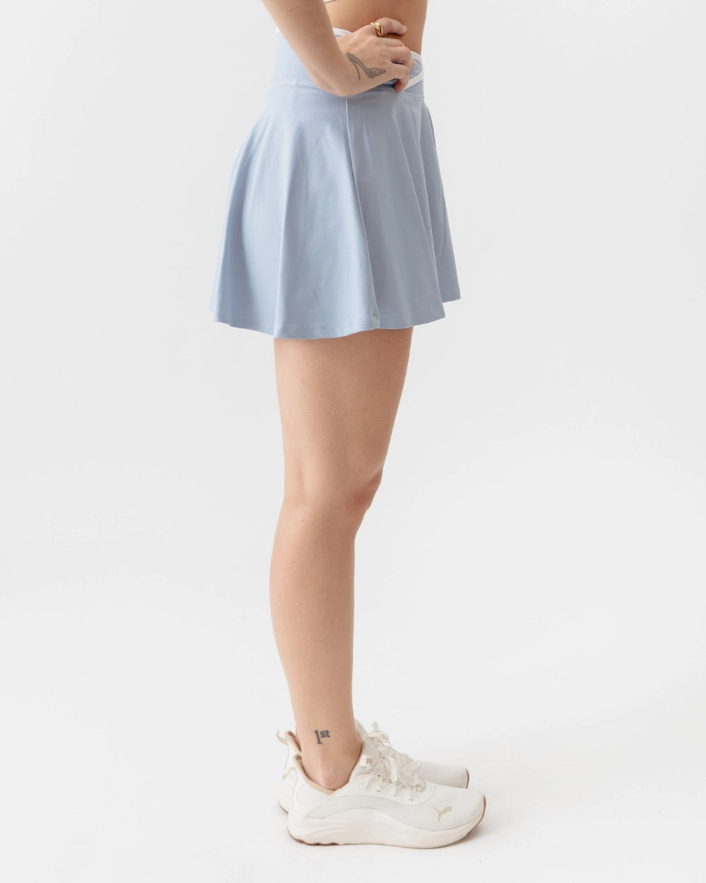 Light blue skirt worn by a person on a white background