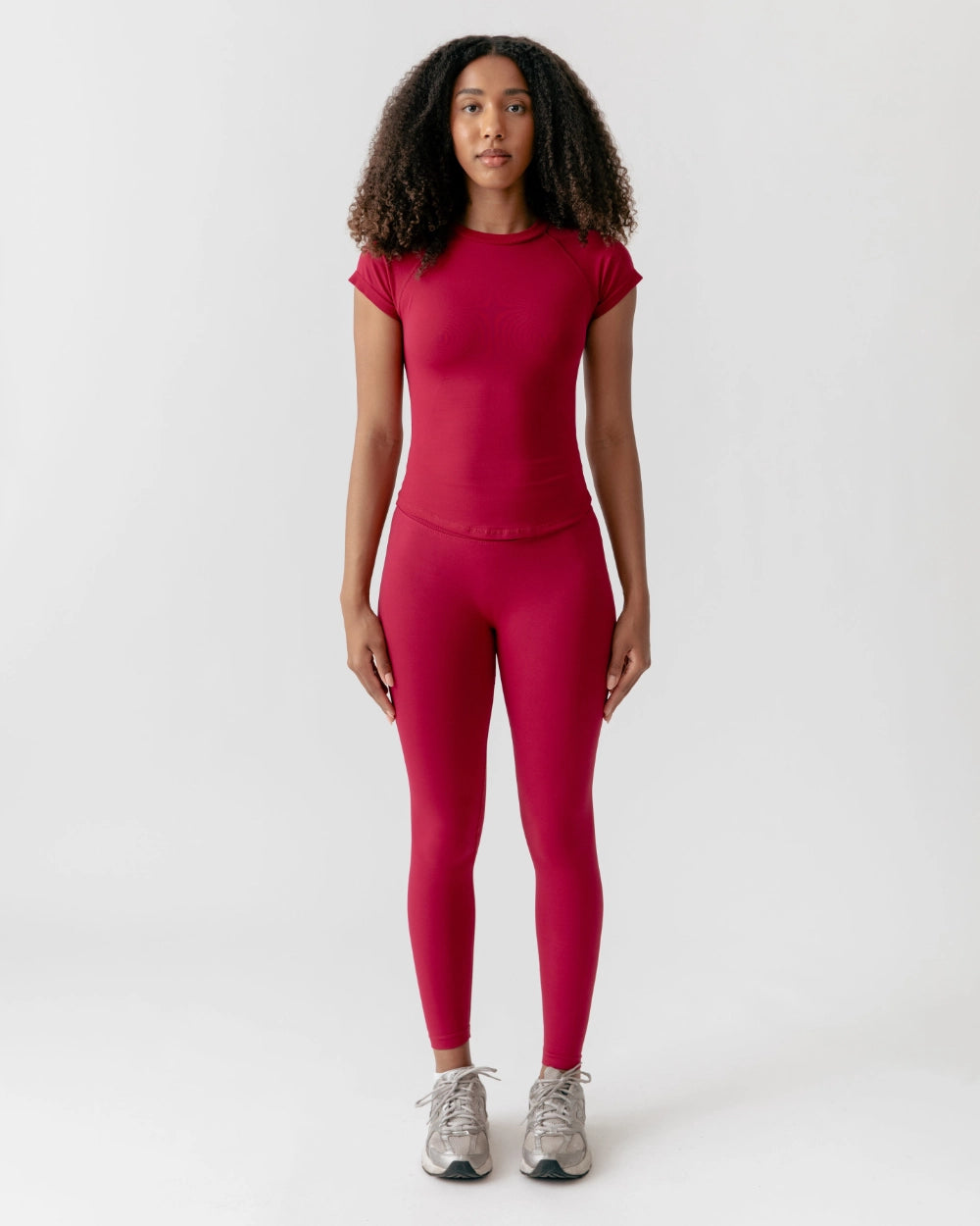 Person wearing a red athletic outfit on a white background