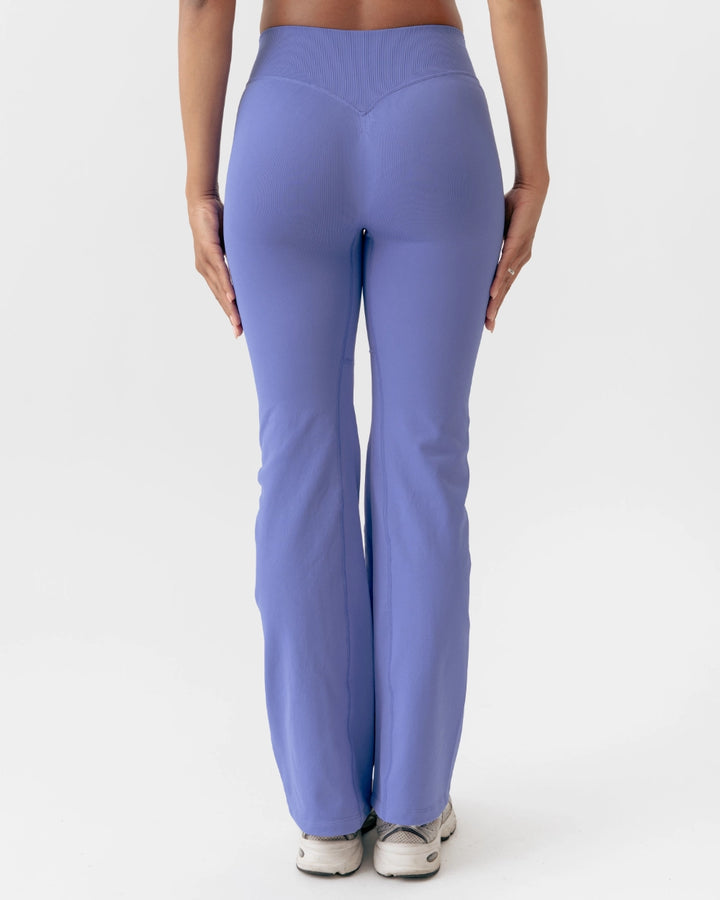 Purple leggings worn by a person on a white background