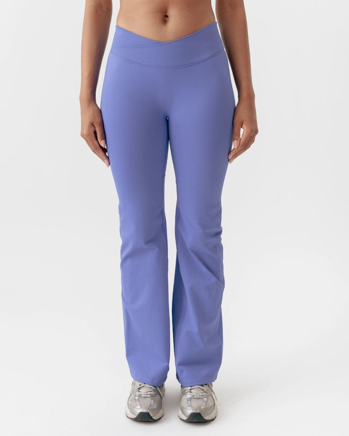 Person wearing purple leggings on a white background