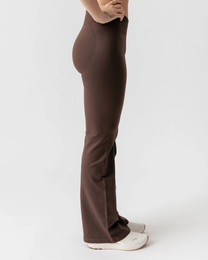 Brown pants worn by a person on a white background