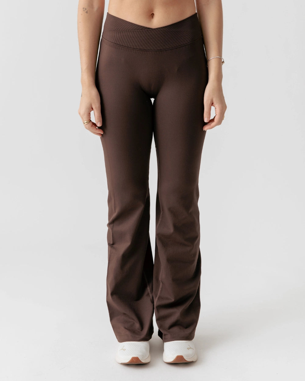 Brown pants worn by a person on a white background