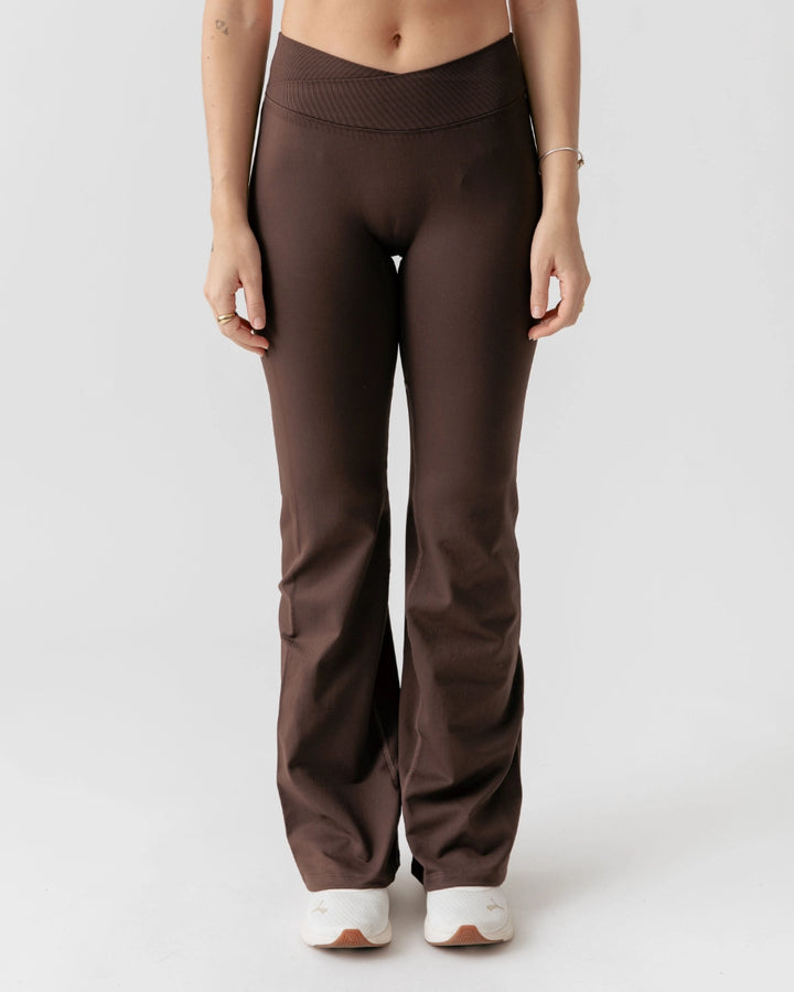 Brown pants worn by a person on a white background
