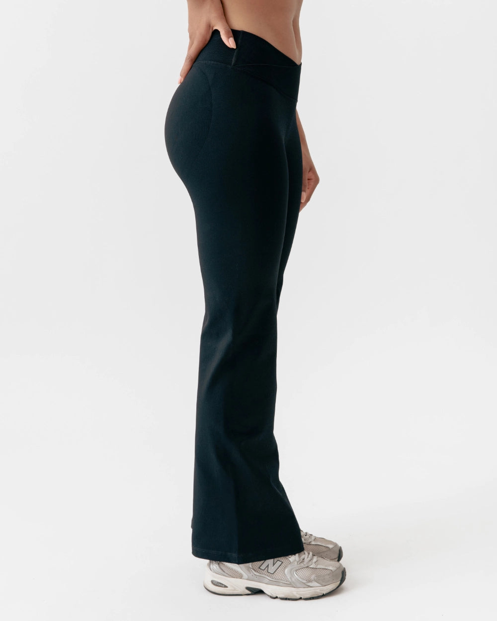 Person wearing black pants on a white background