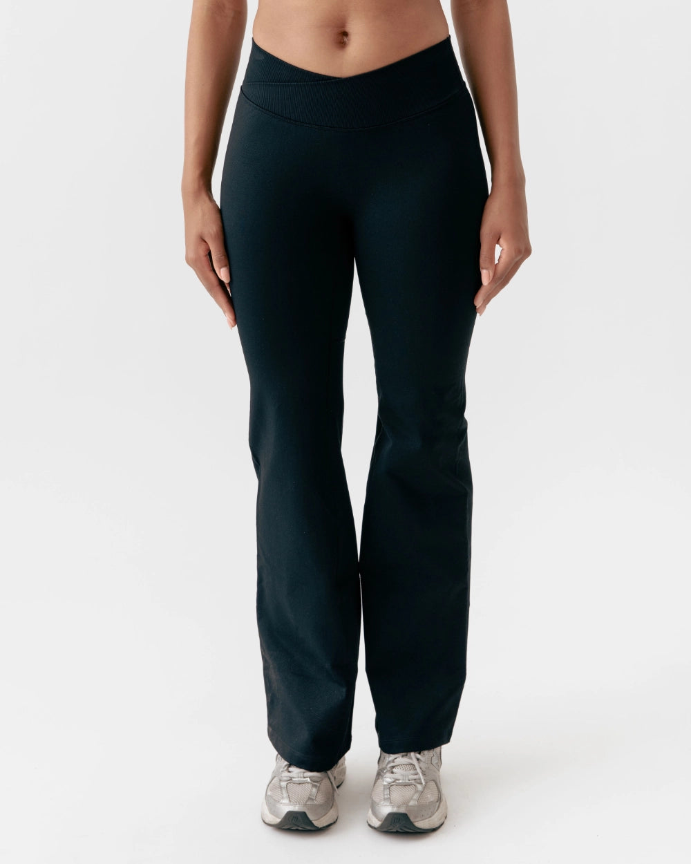 Person wearing black pants on a white background