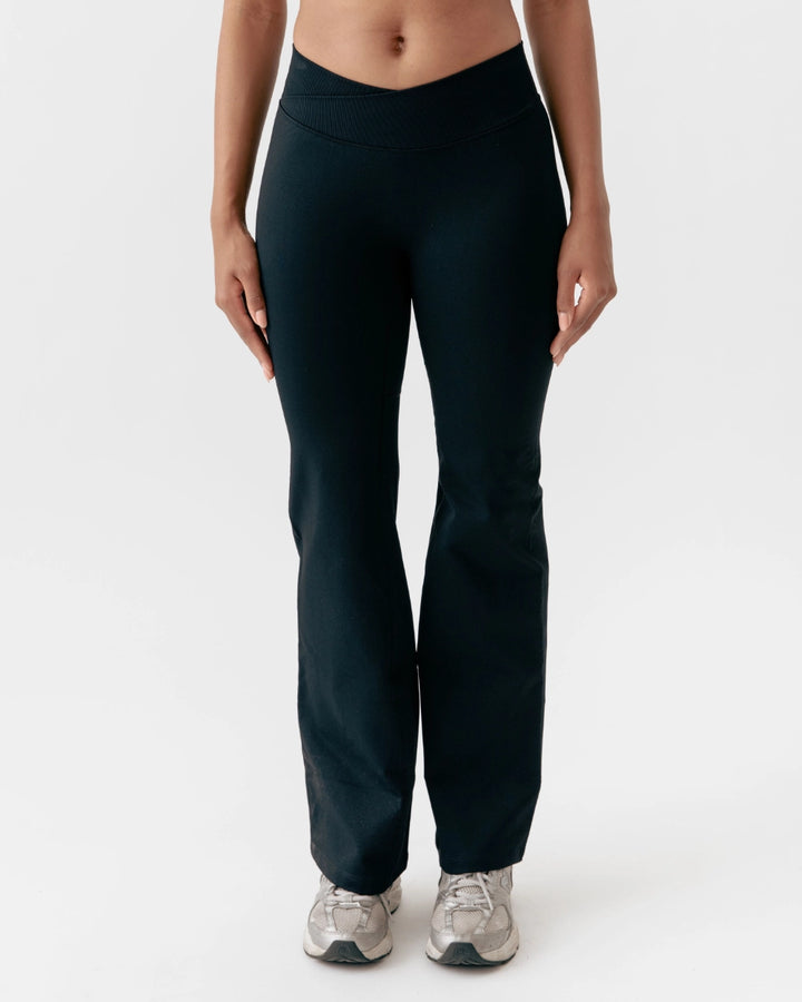 Person wearing black pants on a white background