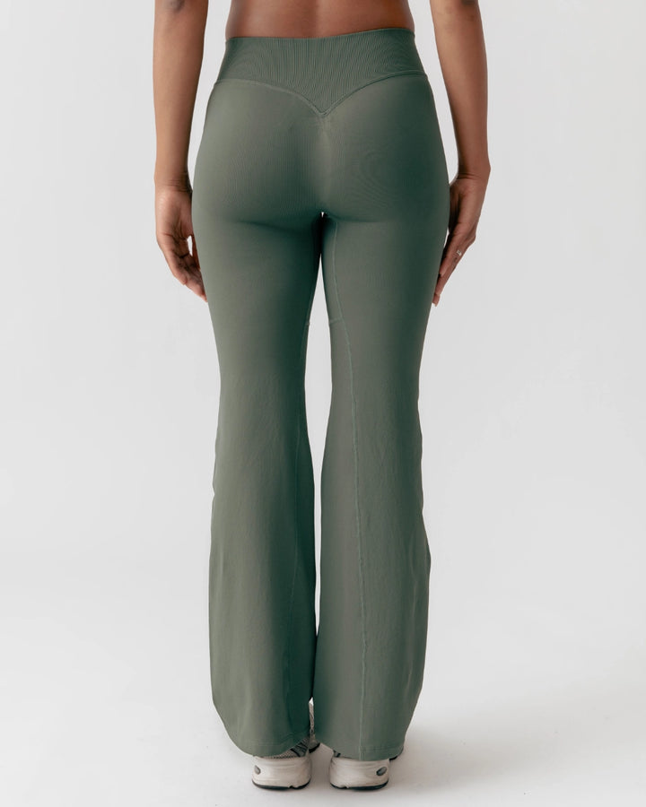 Green leggings worn by a person on a white background