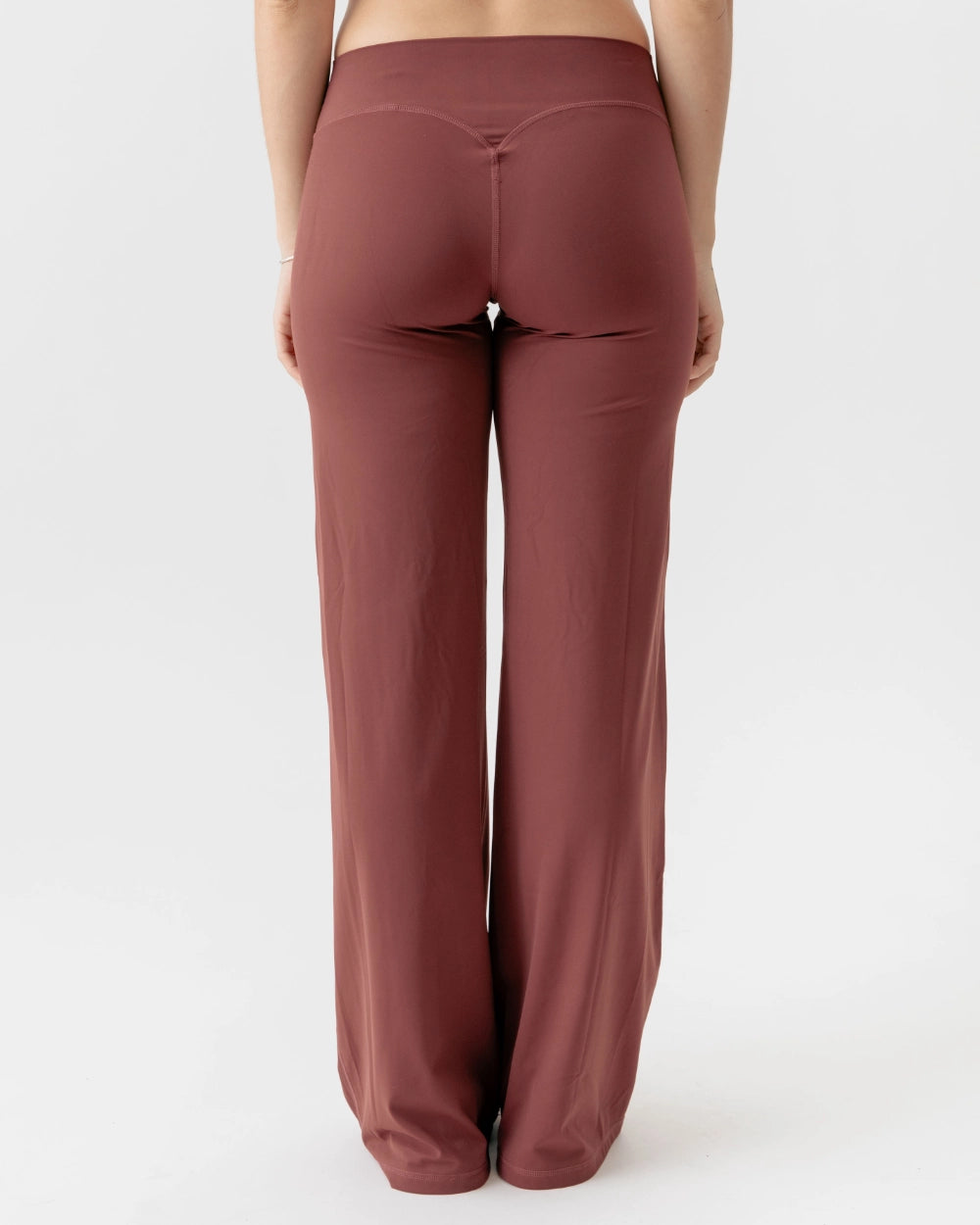 Brown wide-leg pants worn by a person on a white background