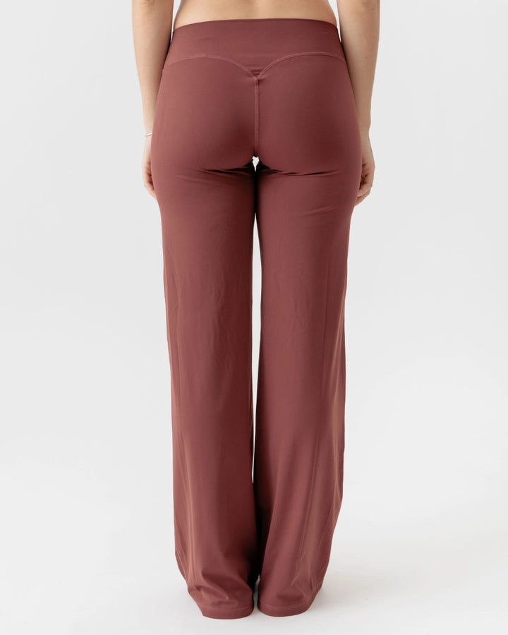 Brown wide-leg pants worn by a person on a white background
