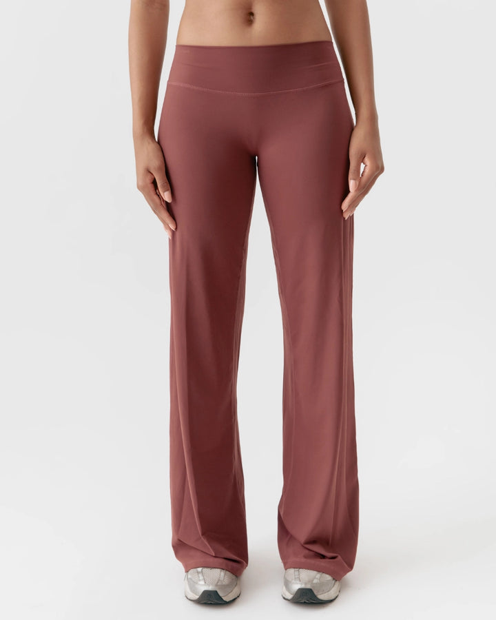 Maroon leggings worn by a person on a white background